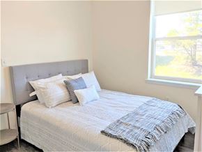 Portland apartment for rent - a bedroom with a bed and a window