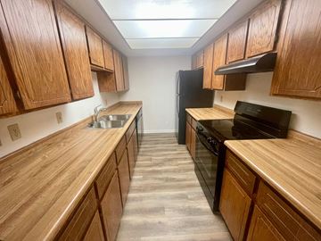 Mesa apartment for rent - a kitchen with wooden cabinets and a stove and a sink