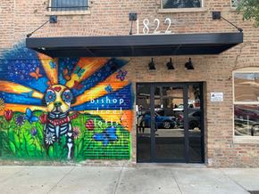 Chicago apartment for rent - the front of a building with a colorful mural and a door