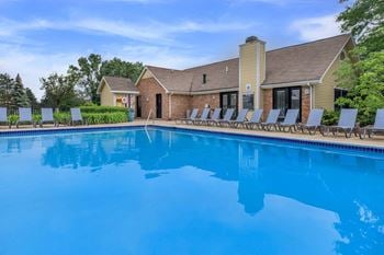Outdoor swimming pool with ample seating and tables