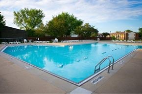Rochester Hills apartment for rent - a swimming pool with chairs around it at a hotel