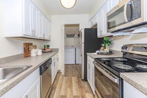 Kalamazoo apartment for rent - a kitchen with white cabinets and stainless steel appliances