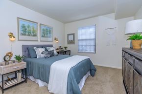 Kalamazoo apartment for rent - a bedroom with a bed and a dresser and a window