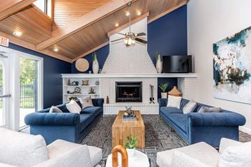 Kalamazoo apartment for rent - a living room with blue couches and a fireplace