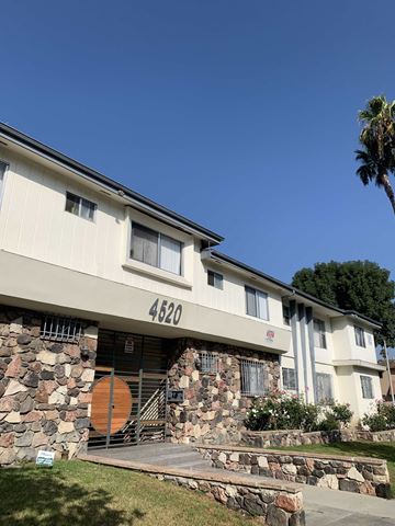 Los Angeles apartment for rent - a white house with a stone wall and a driveway
