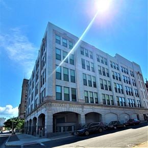 Utica apartment for rent - a large building on the corner of a city street