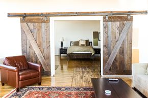 Oakland apartment for rent - A room with a brown leather chair and a rug with a wooden wall.