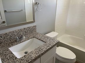 Bakersfield apartment for rent - a bathroom with a sink and a toilet and a mirror