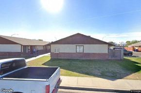 Mesa apartment for rent - A white pickup truck is parked in front of a house.