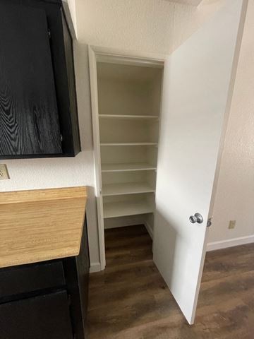 Mesa apartment for rent - A kitchen with a black cabinet and a white door.