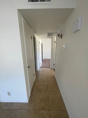 Mesa apartment for rent - A long hallway with a door at the end.
