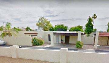 Mesa apartment for rent - A modern house with a white fence and a car parked in front.