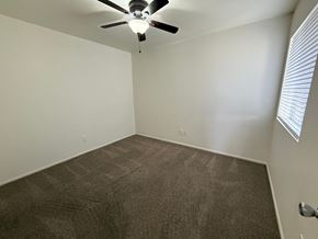 Mesa apartment for rent - A room with a ceiling fan and carpeted floor.