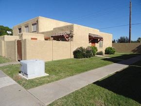 Mesa apartment for rent - A beige house with a brown roof and a white box in front.