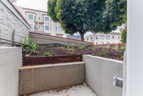 San Francisco apartment for rent - A concrete structure with a tree in the background.