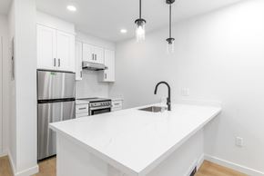San Francisco apartment for rent - A kitchen with white cabinets and a white countertop.