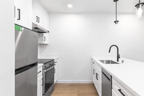 San Francisco apartment for rent - A modern kitchen with a stainless steel refrigerator and white cabinets.