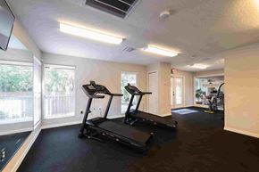 Hudson apartment for rent - A spacious gym with treadmills and a treadmill in the foreground.