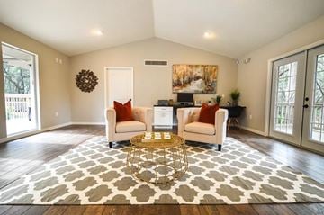 Hudson apartment for rent - A living room with a large rug and two chairs.