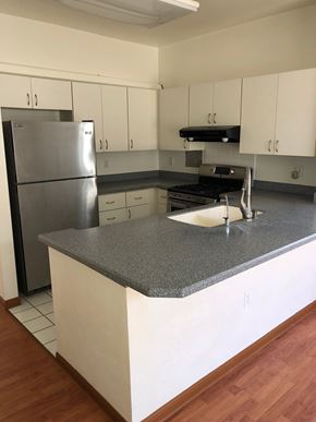 Kapolei house for rent - A kitchen with a granite countertop and stainless steel appliances.