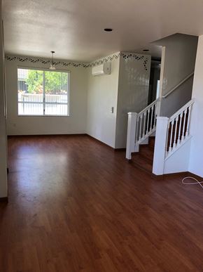 Kapolei house for rent - A room with wooden floors and a staircase.