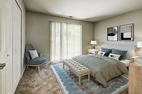 Pittsburgh townhouse for rent - a bedroom with a bed and a chair