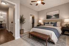 Lexington apartment for rent - A bedroom with a large bed and a ceiling fan.
