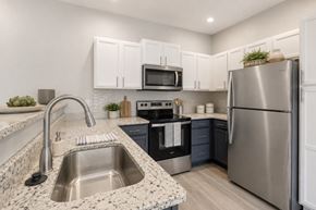 Lexington apartment for rent - A modern kitchen with a stainless steel refrigerator and a marble countertop.