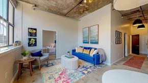 Albany apartment for rent - a living room with a blue couch and a white table