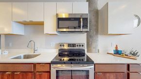 Albany apartment for rent - a kitchen with a stove microwave and sink