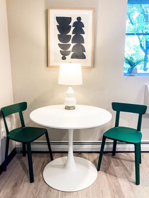 Troy apartment for rent - a dining room with a white table and two green chairs