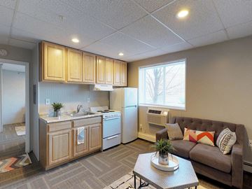 Troy apartment for rent - a living room with a kitchen and a couch
