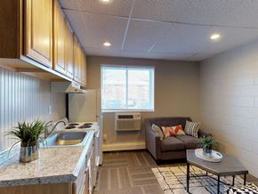 Troy apartment for rent - a small living room with a couch and a kitchen
