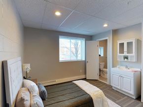 Troy apartment for rent - a bedroom with a bed and a bathroom with a sink