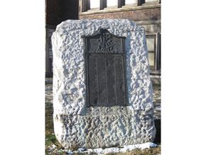 Troy apartment for rent - a black door on a stone wall with a building in the background