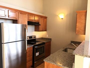 Troy apartment for rent - a kitchen with stainless steel appliances and granite counter tops