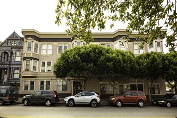 San Francisco apartment for rent - A row of cars are parked in front of a building.