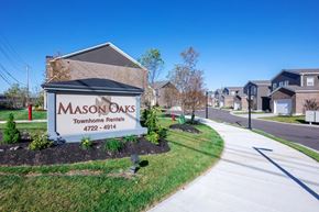 Mason apartment for rent - a community sign townhomes in front of a street