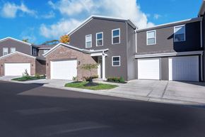 Mason apartment for rent - a house with two garage doors on a street