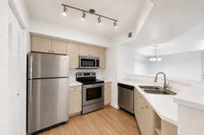Jensen Beach apartment for rent - A modern kitchen with stainless steel appliances and wooden floors.