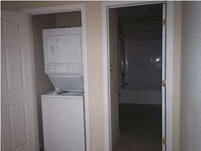 Crestview house for rent - A white microwave oven is built into a cabinet in a room.