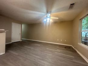 Crestview house for rent - A room with a ceiling fan and a window.