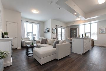 Kingston apartment for rent - A living room with a white couch and a fireplace.
