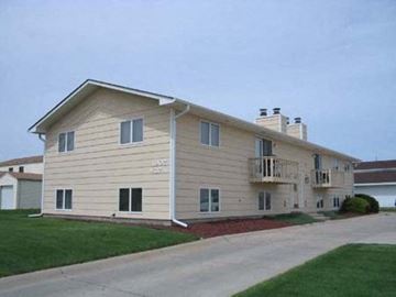Kearney apartment for rent - a white house with a balcony and a driveway
