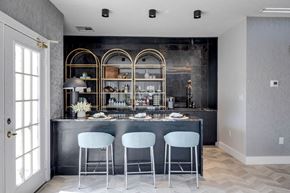 Shelbyville apartment for rent - A kitchen with a bar area featuring a black counter and three white bar stools.