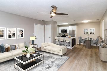 Shelbyville apartment for rent - A modern living room with a glass coffee table and a white sofa.