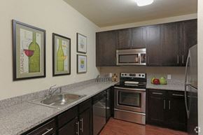 Bridgewater apartment for rent - A kitchen with a stove top oven and a refrigerator.