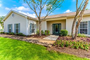Jackson apartment for rent - A house with a green lawn and a tree in front.