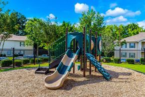 Jackson apartment for rent - A playground with a slide and a green fence.