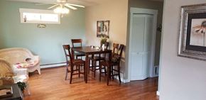 Manhattan house for rent - a dining room with a wooden table and chairs